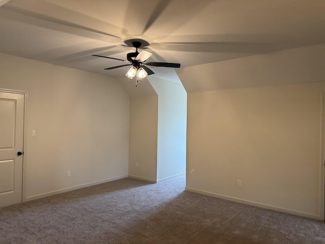 additional living space with carpet floors, a ceiling fan, baseboards, and vaulted ceiling
