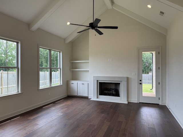 unfurnished living room with a fireplace, plenty of natural light, high vaulted ceiling, dark wood-style flooring, and beamed ceiling