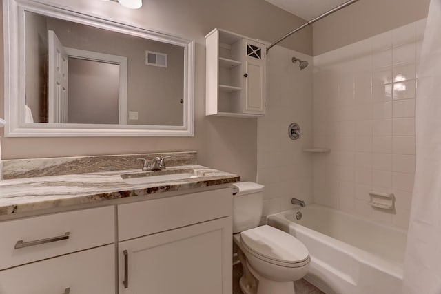 bathroom featuring toilet, vanity, and shower / bath combo