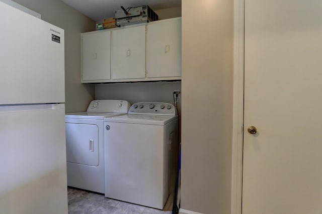 laundry area with cabinet space and washing machine and clothes dryer