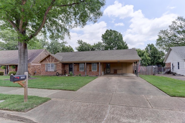 ranch-style home with driveway, a carport, a shingled roof, and brick siding