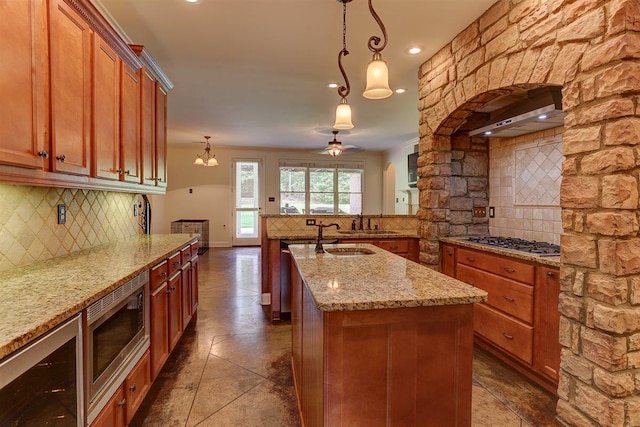 100 Whitehall Ct, Unicorp/Eads, TN 38028 - kitchen featuring appliances with stainless steel finishes, backsplash, brown cabinetry, light stone countertops, and recessed lighting