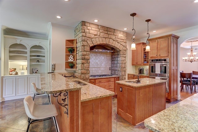 100 Whitehall Ct, Unicorp/Eads, TN 38028 - kitchen featuring crown molding, a sink, appliances with stainless steel finishes, open shelves, and a kitchen island with sink