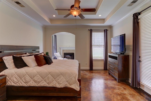 100 Whitehall Ct, Unicorp/Eads, TN 38028 - bedroom with baseboards, a fireplace, a tray ceiling, arched walkways, and ornamental molding