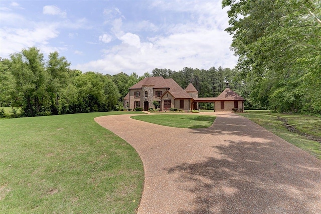 100 Whitehall Ct, Unicorp/Eads, TN 38028 - french country inspired facade with a front yard, stone siding, a chimney, a wooded view, and driveway