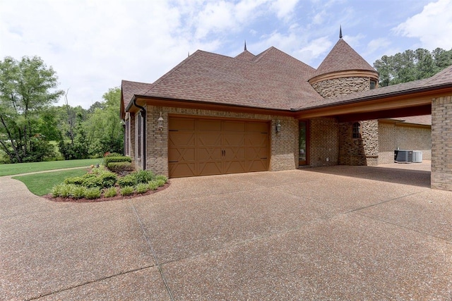 100 Whitehall Ct, Unicorp/Eads, TN 38028 - view of home's exterior featuring driveway, central AC unit, an attached garage, brick siding, and a lawn