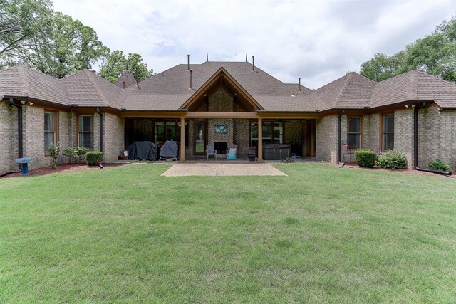 100 Whitehall Ct, Unicorp/Eads, TN 38028 - rear view of house featuring a patio, a lawn, and brick siding