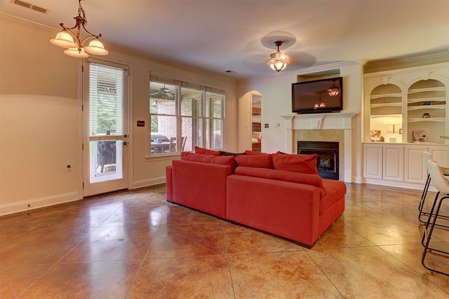100 Whitehall Ct, Unicorp/Eads, TN 38028 - tiled living room with crown molding, arched walkways, a tile fireplace, and baseboards