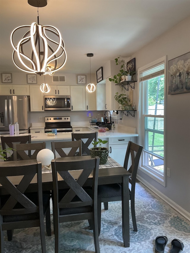 6288 Martinwest Dr, Millington, TN 38053 - dining room with a chandelier and baseboards