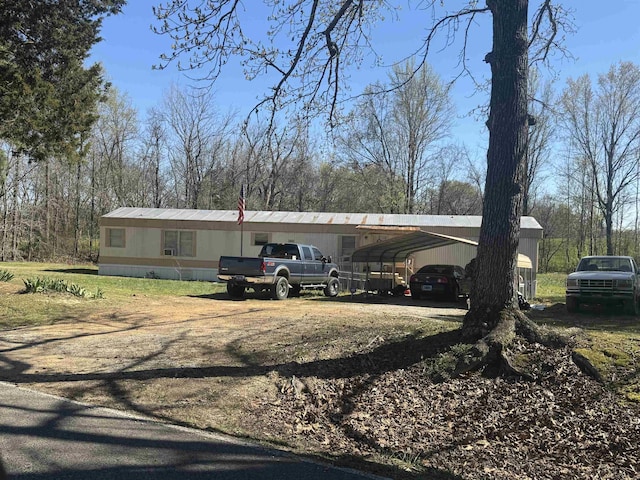 5137 Old Brownsville Rd, Ripley, TN 38063 - view of property exterior with a detached carport and dirt driveway