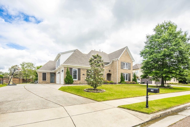 view of front of property featuring brick siding, driveway, a garage, and a shingled roof
