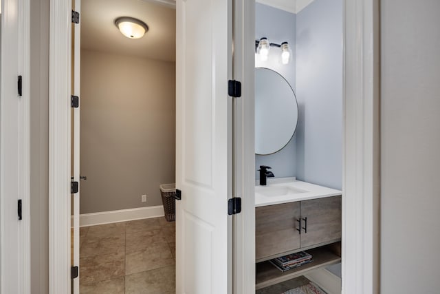 bathroom with vanity, baseboards, and tile patterned flooring