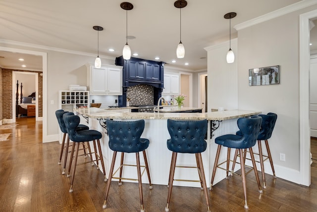 kitchen with dark wood finished floors, decorative backsplash, baseboards, recessed lighting, and ornamental molding