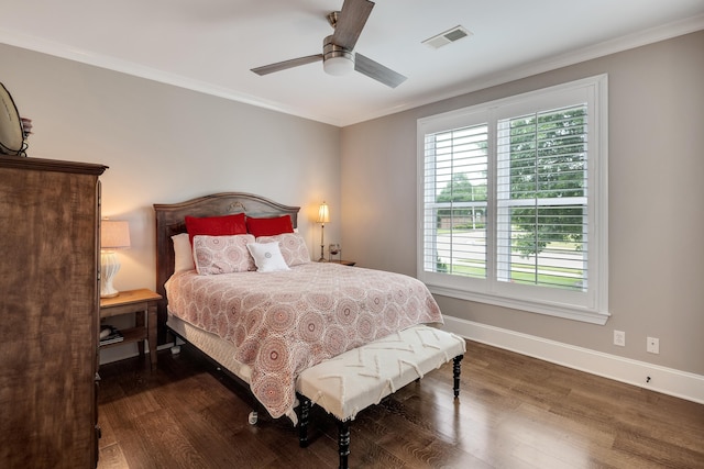 bedroom featuring wood finished floors, ornamental molding, baseboards, and a ceiling fan