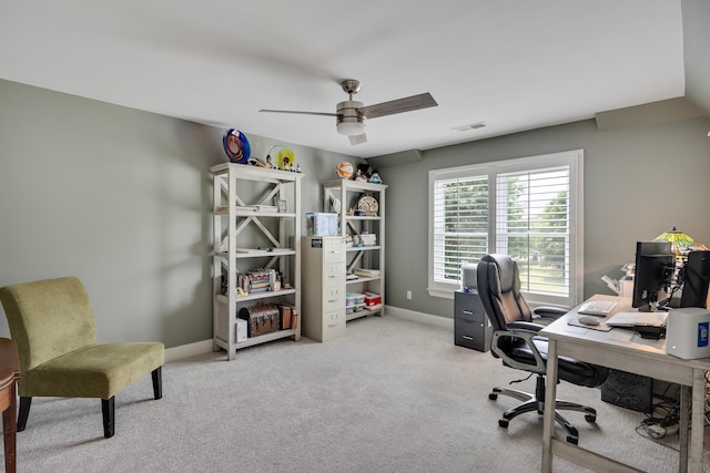 carpeted office featuring a ceiling fan and baseboards