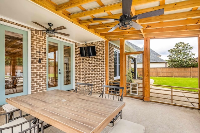 sunroom / solarium with ceiling fan, french doors, outdoor dining space, and beam ceiling