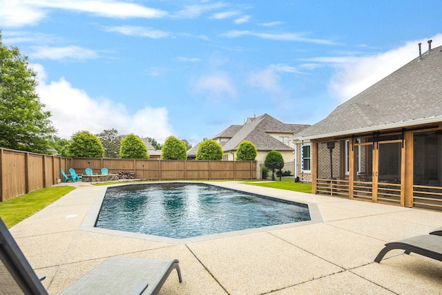 view of pool featuring a patio, an outdoor fire pit, and a fenced backyard