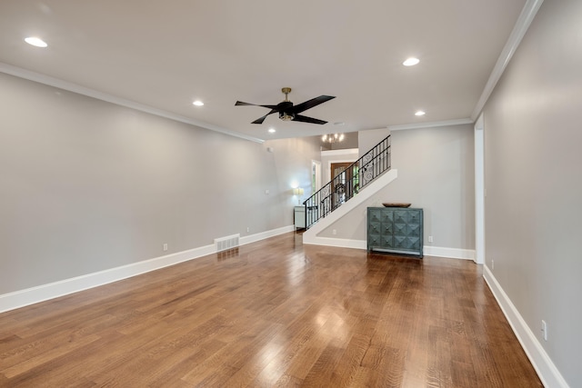 unfurnished living room featuring ornamental molding, stairs, a ceiling fan, wood finished floors, and recessed lighting