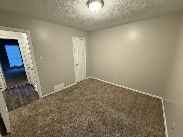 4034 Edgehill St, Memphis, TN 38128 - empty room with dark colored carpet, baseboards, and a textured ceiling