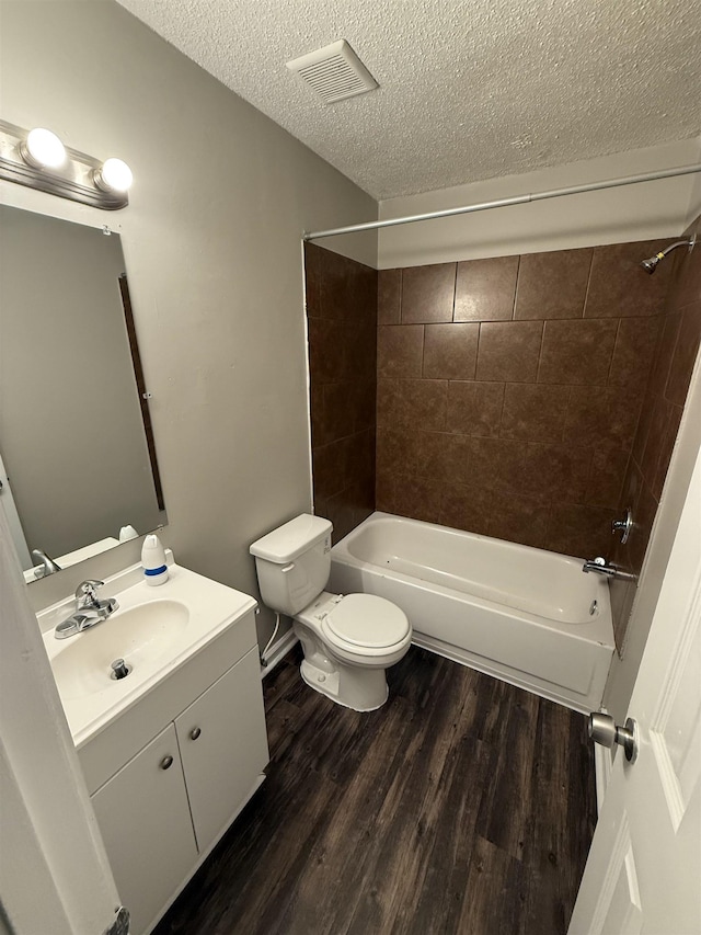 4034 Edgehill St, Memphis, TN 38128 - bathroom with toilet, wood finished floors, shower / washtub combination, a textured ceiling, and vanity