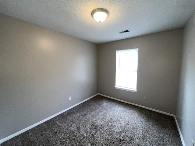 4034 Edgehill St, Memphis, TN 38128 - spare room featuring dark colored carpet, baseboards, and a textured ceiling