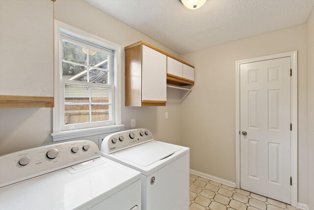 8450 Stoksund Cv, Memphis, TN 38018 - clothes washing area with cabinet space, independent washer and dryer, baseboards, and a textured ceiling