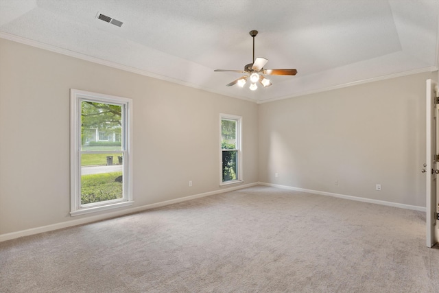 spare room with crown molding, a ceiling fan, healthy amount of natural light, and light carpet