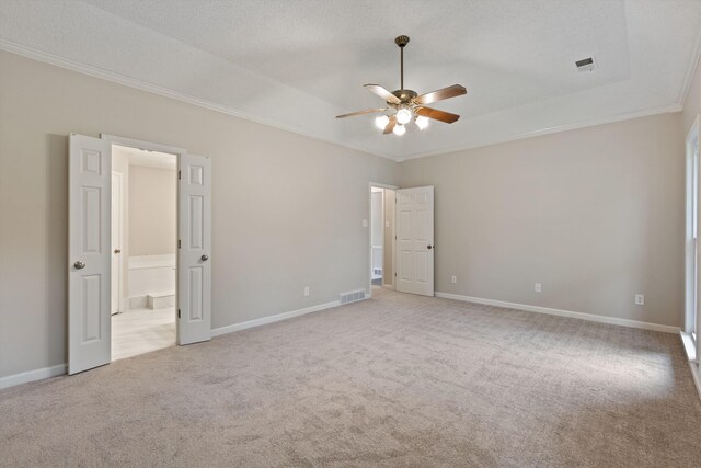 8450 Stoksund Cv, Memphis, TN 38018 - unfurnished bedroom featuring ornamental molding, light carpet, baseboards, connected bathroom, and a raised ceiling