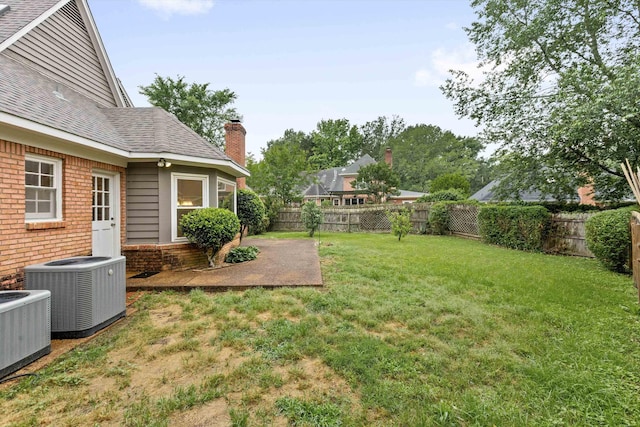 view of yard featuring central AC and a patio area