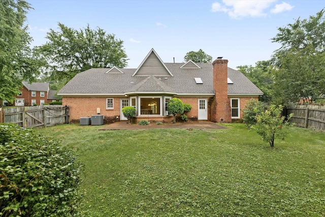 rear view of house with brick siding, a patio area, central AC, and a chimney