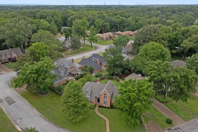 aerial view of residential area featuring a forest