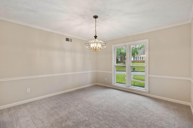 carpeted empty room with a textured ceiling, a chandelier, crown molding, and baseboards