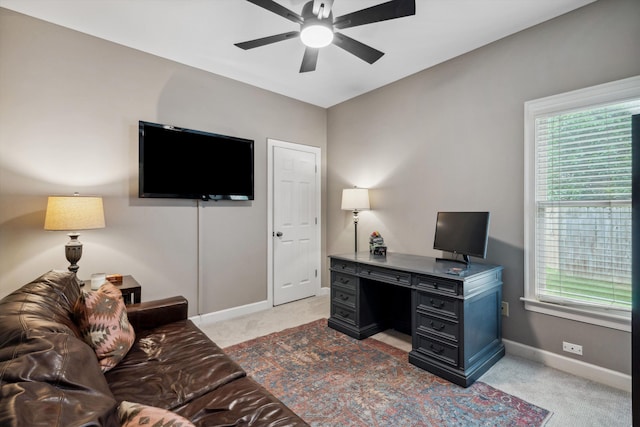 office space with a ceiling fan, light colored carpet, and plenty of natural light