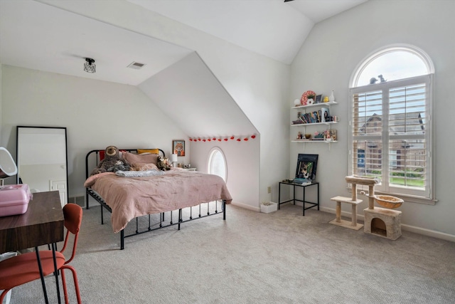 bedroom with vaulted ceiling, multiple windows, carpet flooring, and baseboards