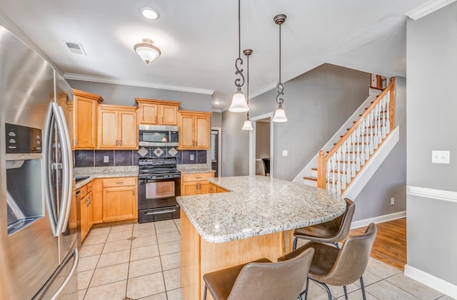kitchen featuring stainless steel appliances, light tile patterned floors, a kitchen island, backsplash, and a breakfast bar area