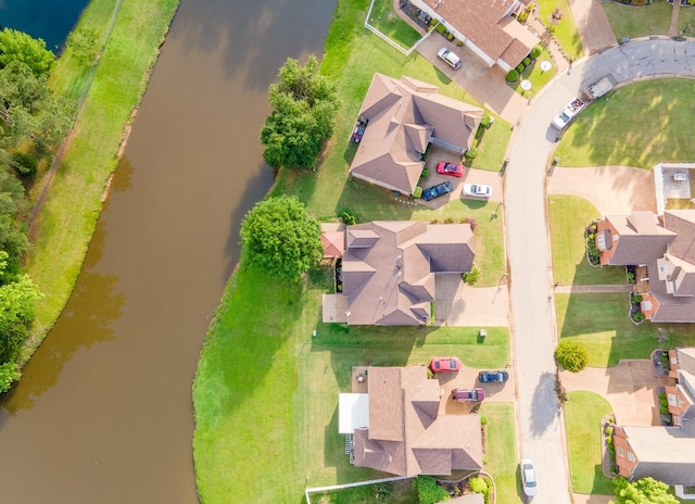 aerial perspective of suburban area with a nearby body of water