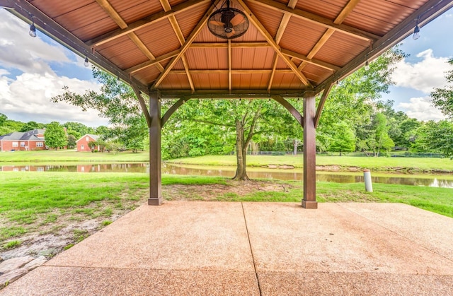 view of patio / terrace featuring a gazebo, a water view, and view of scattered trees