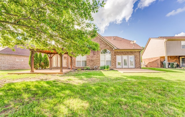 rear view of property featuring a pergola, french doors, a yard, brick siding, and a patio area