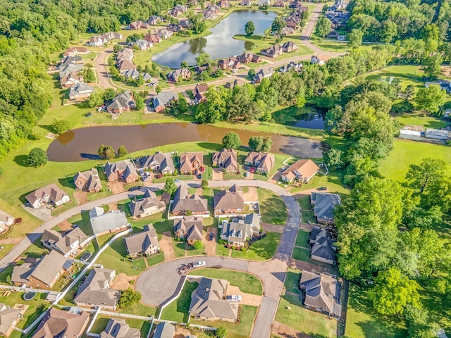aerial view of property's location with a large body of water and nearby suburban area