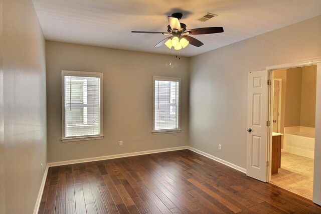 1354 E Island Pl, Memphis, TN 38103 - empty room featuring dark wood-style floors, ceiling fan, and healthy amount of natural light