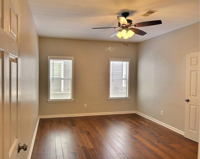 1354 E Island Pl, Memphis, TN 38103 - unfurnished room with healthy amount of natural light, baseboards, dark wood-style flooring, and ceiling fan