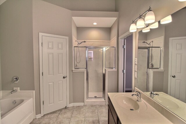 1354 E Island Pl, Memphis, TN 38103 - full bathroom featuring a shower stall, tile patterned flooring, a garden tub, vanity, and baseboards