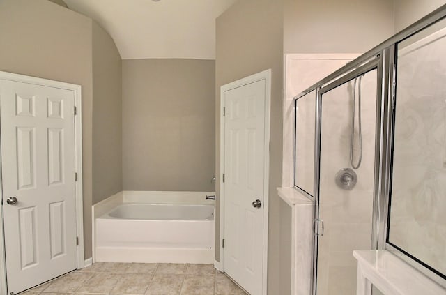 1354 E Island Pl, Memphis, TN 38103 - full bathroom featuring a bath, a shower stall, tile patterned floors, and lofted ceiling