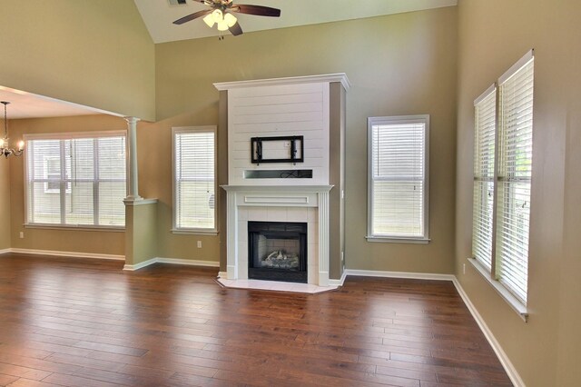 1354 E Island Pl, Memphis, TN 38103 - unfurnished living room featuring ceiling fan, high vaulted ceiling, a tile fireplace, dark wood-style floors, and a chandelier