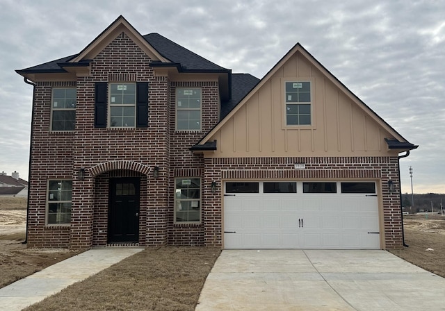 2828 Epping Crest Cv, Memphis, TN 38128 - view of front facade featuring driveway, board and batten siding, brick siding, and roof with shingles