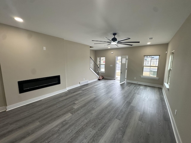 2828 Epping Crest Cv, Memphis, TN 38128 - unfurnished living room featuring a glass covered fireplace, dark wood-type flooring, stairway, ceiling fan, and recessed lighting