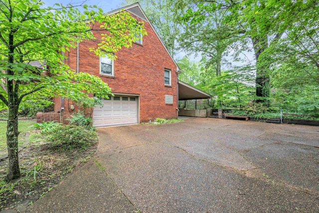 6196 Ivanhoe Cv, Bartlett, TN 38134 - view of property exterior with driveway, an attached garage, brick siding, and a carport