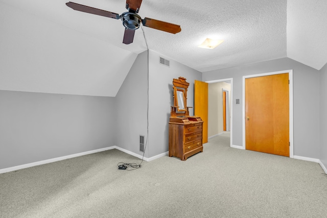 6196 Ivanhoe Cv, Bartlett, TN 38134 - additional living space featuring carpet floors, ceiling fan, vaulted ceiling, baseboards, and a textured ceiling