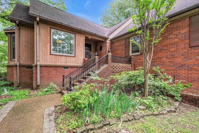 6196 Ivanhoe Cv, Bartlett, TN 38134 - view of front facade featuring brick siding, stairway, and roof with shingles