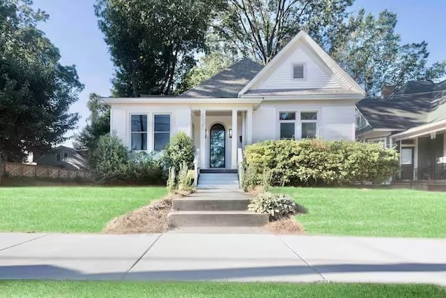 bungalow-style home featuring a front lawn